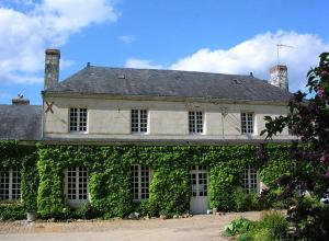 a building covered in ivy with at La Mesnagerie in Jarzé