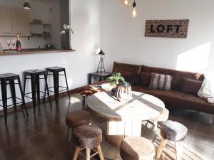 a living room with a table and a couch at le 104 - Disneyland Paris - in Magny-le-Hongre