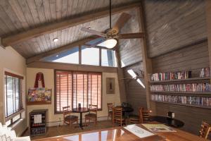 a dining room with a ceiling fan and bookshelves at The Maxwell Inn in Estes Park