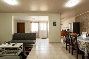 a living room with a couch and a table at Casa Piscinas Naturais in Ribeira Grande
