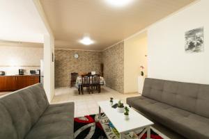 a living room with a couch and a table at Casa Piscinas Naturais in Ribeira Grande