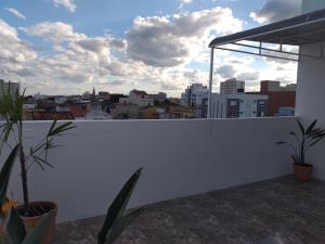 a white wall with a view of a city at Pousada Tchê Aprochega in Pelotas
