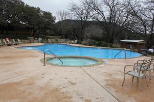 a large swimming pool with a chair and a bench at Medina Highpoint RV Resort in Medina