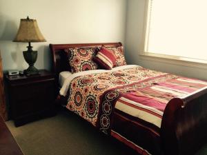 a bedroom with a bed and a lamp and a window at Luxury 5 Bedroom Home near SFO in San Bruno