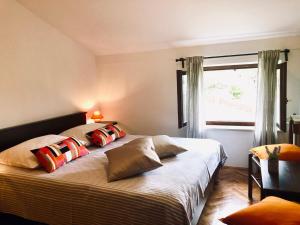 a bedroom with two beds with pillows and a window at Apartments Petricic with swimming pool in Ičići