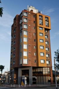 a tall brick building on a city street at Hotel Tres Cruces in Montevideo