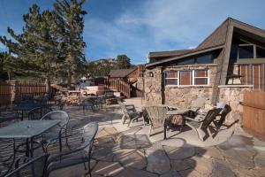 a patio with tables and chairs in front of a building at The Maxwell Inn in Estes Park