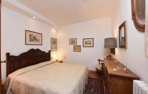 a bedroom with a large bed and a wooden table at San Marco Garden House in Venice