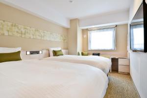 Un pat sau paturi într-o cameră la Vessel Inn Chiba Ekimae