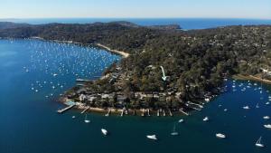 an aerial view of a small island with boats in the water at Refuge Cove On Pittwater in Clareville