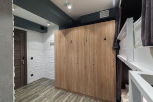 a closet with a wooden door in a room at Islander Mini - Hotel in Yuzhno-Sakhalinsk