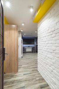 a hallway with a brick wall and a door at Islander Mini - Hotel in Yuzhno-Sakhalinsk