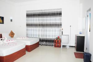 Letto o letti in una camera di Sunstar Nilaveli