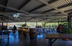 a patio with tables and chairs and people sitting at tables at Criterion Hotel Gundagai in Gundagai