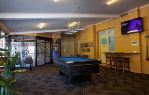 a billiard room with a pool table and a bar at Criterion Hotel Gundagai in Gundagai
