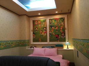 a room with two beds and a window with a painting at Dear Place(Adult Only) in Osaka
