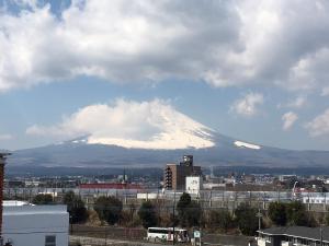 a view of a snow covered mountain in a city at Hotel Lumiere Gotenba (Adult Only) in Gotemba