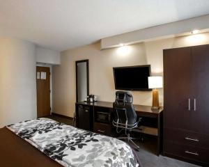 a hotel room with a bed and a desk with a computer at Sleep Inn Nashville - Brentwood - Cool Springs in Brentwood