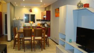 a kitchen and dining room with a table and chairs at Althea's nice, comfy 4 BR townhouse with pool in Grand Bay- AH 1 in Grand-Baie