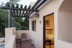 a patio with a bed and a door to a bedroom at Casa Del Sol in Carpinteria