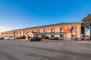 a large building with a coke sign in a parking lot at Econo Lodge in Lexington