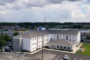 an aerial view of a large white building with a parking lot at Sleep Inn Sandusky in Sandusky
