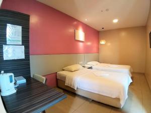 Postel nebo postele na pokoji v ubytování Hotel Jelai @ Temerloh, Pahang