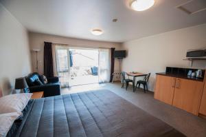 a bedroom with a bed and a table with a chair at Jafa's Motels in Lawrence