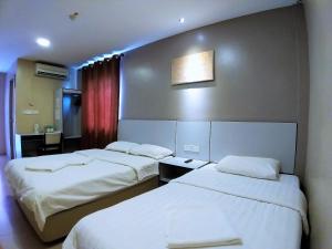 Postel nebo postele na pokoji v ubytování Hotel Jelai @ Temerloh, Pahang