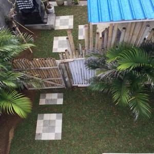 an aerial view of a yard with a pool and palm trees at Laksmi Guest House in Canggu