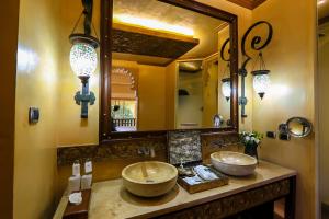 a bathroom with two sinks and a large mirror at Sawasdee Village in Kata Beach