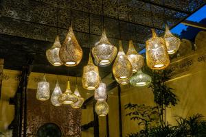 a group of lights hanging from a ceiling at Sawasdee Village in Kata Beach