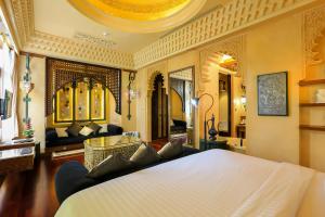 a bedroom with a large white bed in a room at Sawasdee Village in Kata Beach