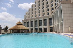 a large swimming pool in front of a building at Ethiopian Skylight Hotel in Addis Ababa