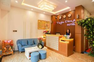 a woman standing at the counter of a dental office at Khách sạn Triều Dâng in Tuy Hoa