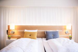 Ліжко або ліжка в номері Comwell Hvide Hus Aalborg