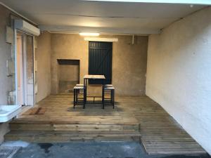 a room with two chairs and a table on a wooden floor at Studio Gallieni in La Châtre +2 photos