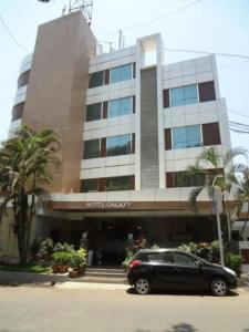 a black car parked in front of a building at Galaxy Beacon Hotel, Santacruz ,Mumbai in Mumbai