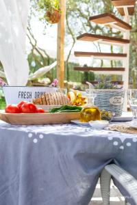 a table with a blue table cloth and vegetables on it at Can Marc in Vilafranca de Bonany