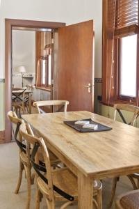 a dining room with a wooden table and chairs at Seal Rocks Lighthouse Cottages in Seal Rocks