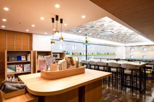 un restaurant avec un bar avec des tabourets et une salle à manger dans l'établissement Comfort Hotel Tokyo Higashi Nihombashi, à Tokyo