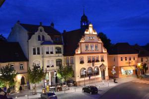 a large building with a clock tower on top of it at Ferienzimmer Therme Natur - Ferienhaus "Zum Goldenen Löwen" in Bad Rodach
