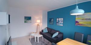 a living room with a couch and a table at F3 - "Gemütlich mit Kunst" in Dresden