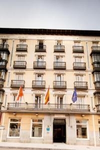 a building with flags on the front of it at Hotel Infantas by MIJ in Madrid