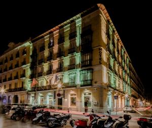 a large building with motorcycles parked in front of it at Hotel Infantas by MIJ in Madrid