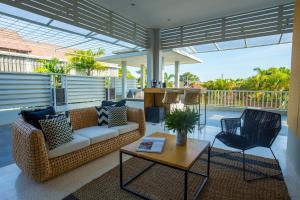 a living room with a couch and a table and chairs at Origin Seminyak in Seminyak