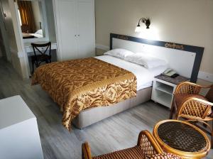 a hotel room with a bed and a table and chairs at Hali Hotel in Istanbul