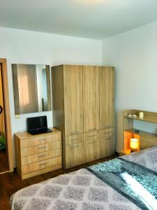a bedroom with a bed and a dresser with a television at Byala Apartments BSR 7 in Byala