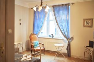 a living room with a chair and a window at Belle Epoque in Poznań