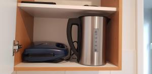 a coffee pot and a printer sitting on a shelf at B&b Broodhuis Kerkrade in Kerkrade